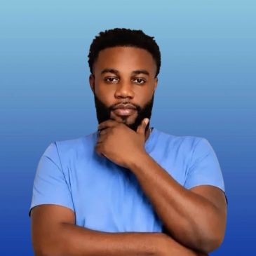 Man in blue shirt posing thoughtfully.