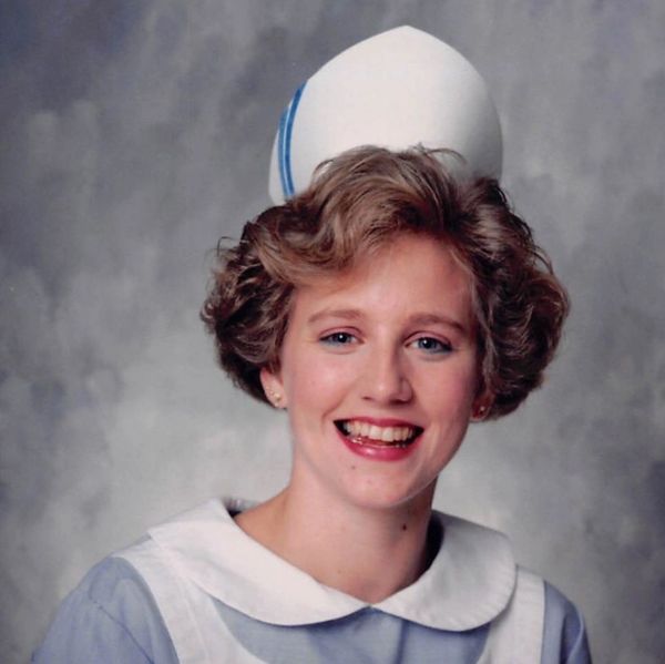 Young nurse in uniform smiling.