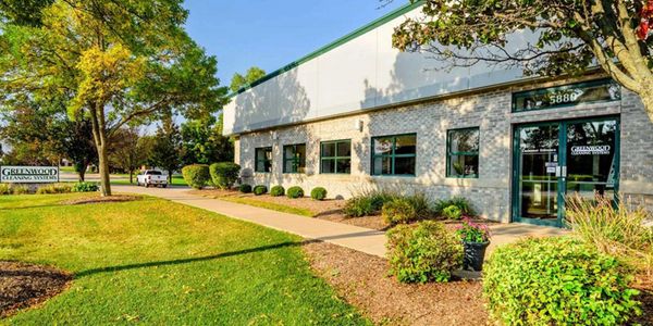 Beautiful store front with grass and bushes
