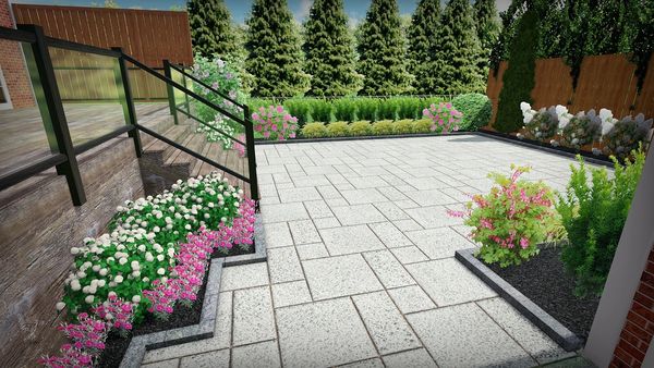 Modern backyard patio with tiled floor and colorful flower beds.
