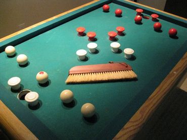 The Bed Brush on a bumper pool table