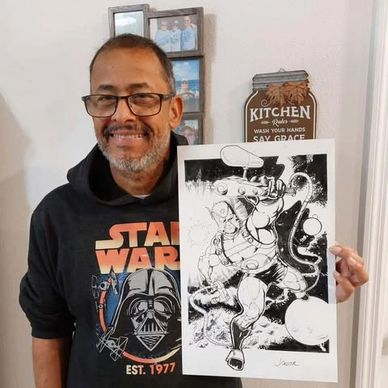 Man smiling and holding detailed black-and-white comic art.