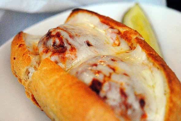 Close-up of a cheesy meatball sub.






