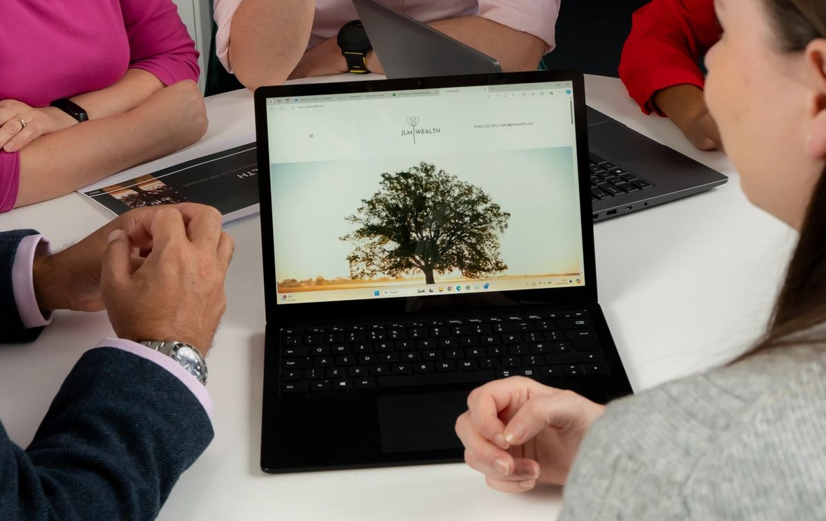 A photo of the JLM Wealth team at a meeting