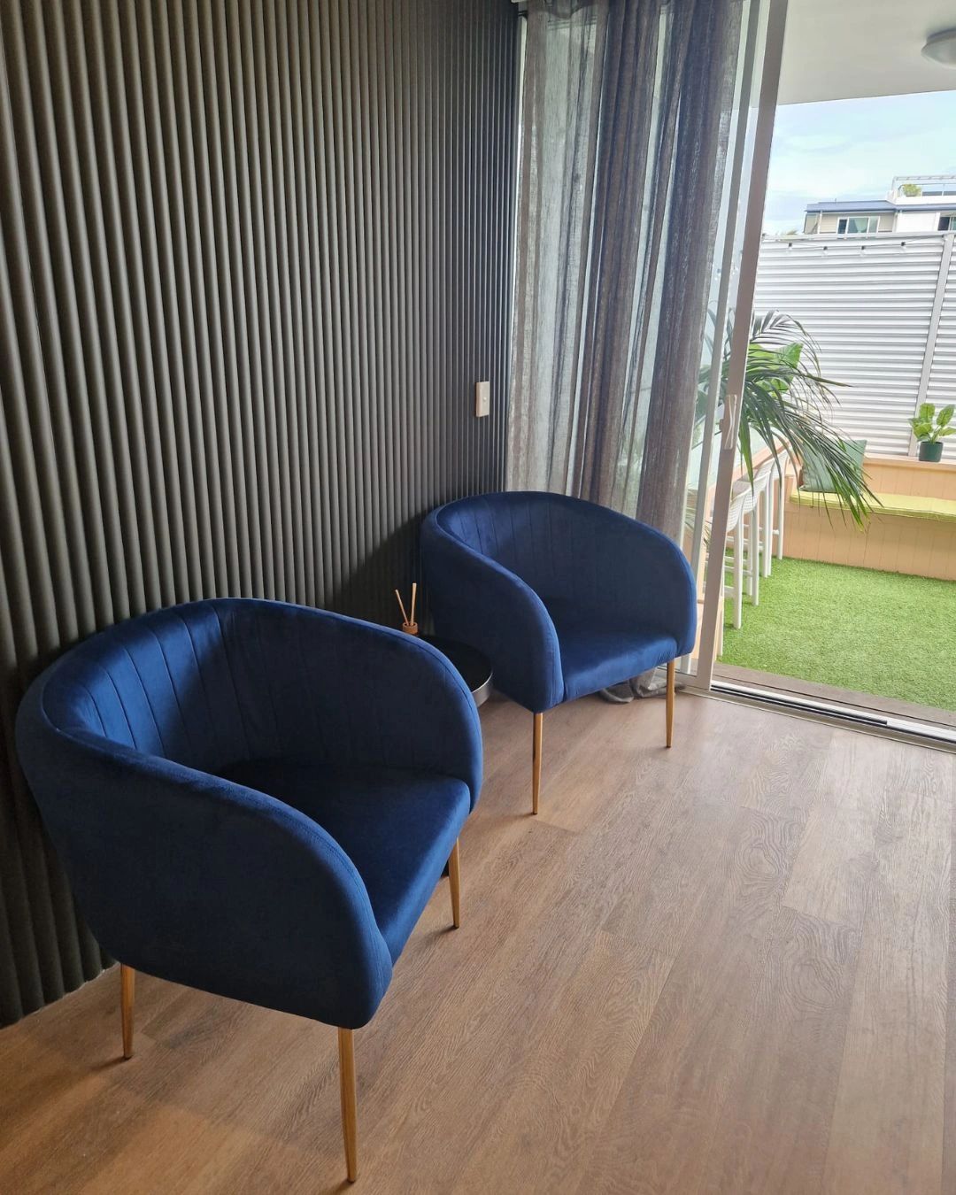 Comfortable client seating beside the outdoor terrace at Noosa Suites Co in Noosaville