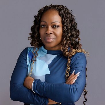 Confident woman with curled hair and crossed arms.