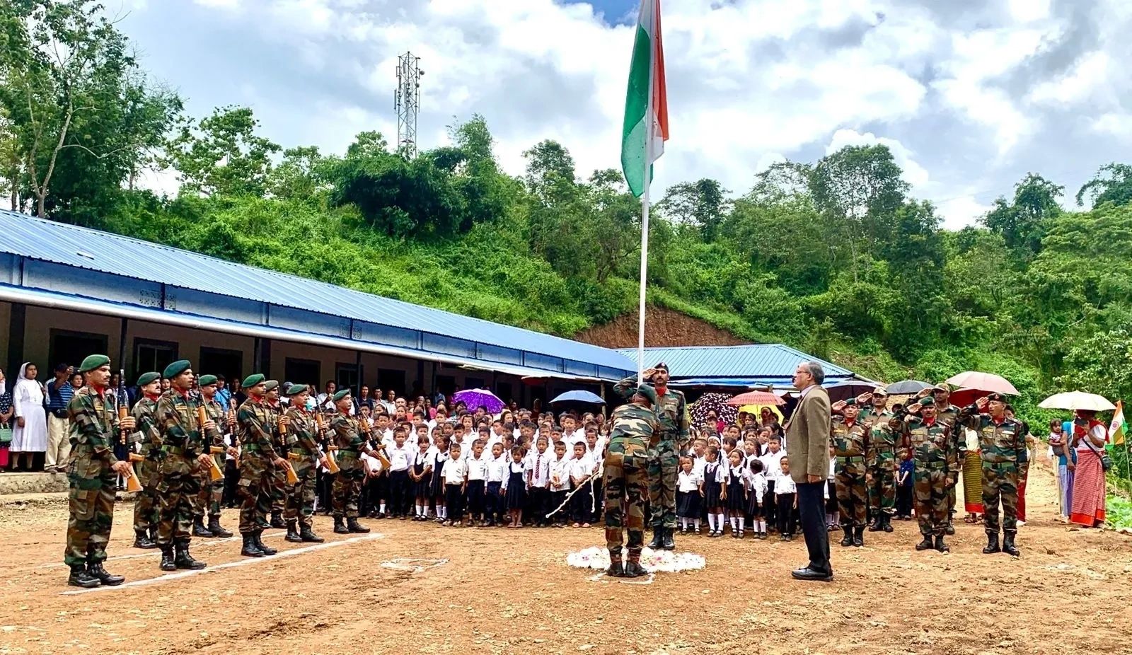 Indian army soldiers and schoolchildren during flag hoisting ceremony.
