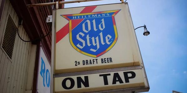 Old Style draft beer sign hanging outside a building.