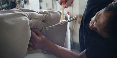 man hammering, upholstering 