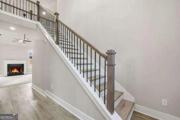 Modern staircase with wooden steps and metal rails.