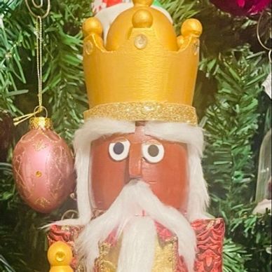 Wooden nutcracker with a golden crown.