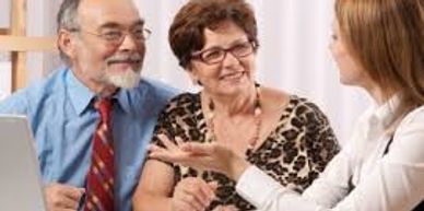 Older couple having conversation with counselor.
