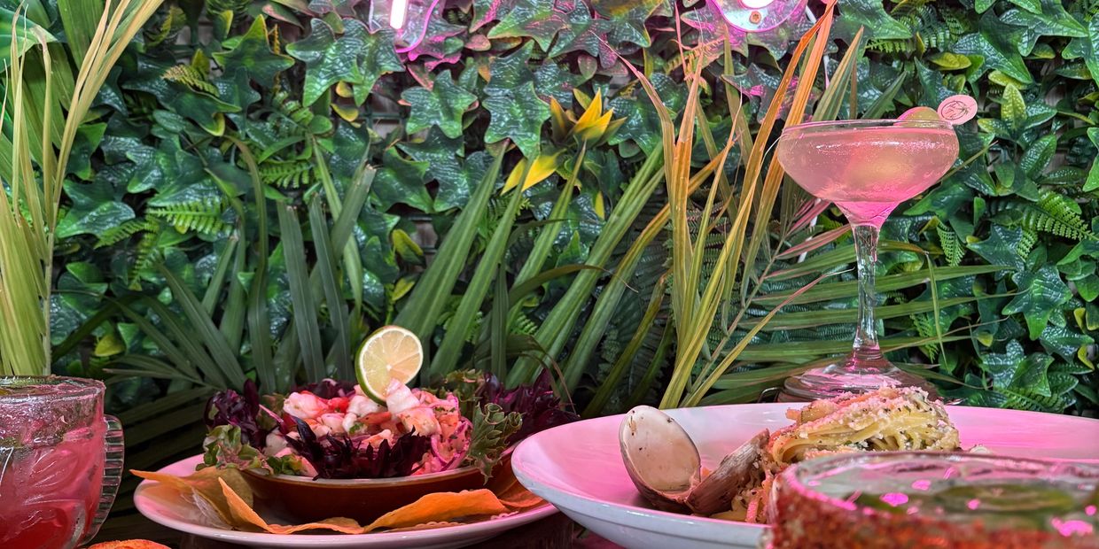 A beautifully set table showcasing food and drinks at Long Island's The Tiki @ Sunset Harbour, 