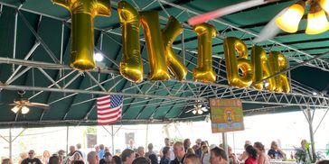 A picture of a happy crowd at The Tiki Bar listening to live music