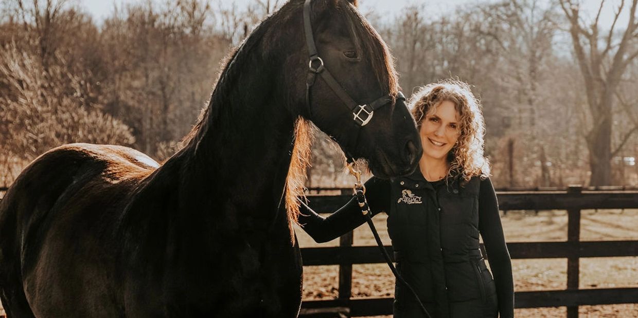 Alicia Cannon holding a horse at Legacy Sport Horses