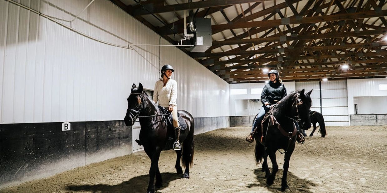 Alicia Cannon and Melissa Hamilton riding horses at a Legacy Sport Horses retreat