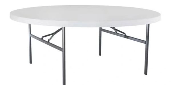 Round white folding table with metal legs.