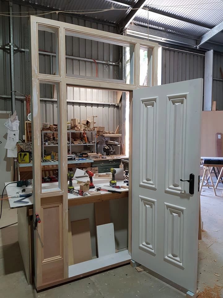 Traditional door frame and white door in the workshop.