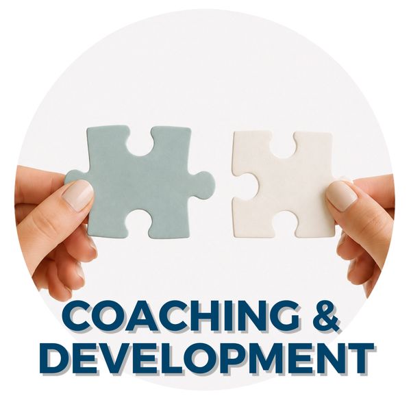 Two hands holding puzzle pieces symbolizing coaching and development.