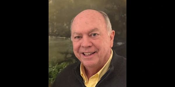 Smiling elderly man indoors.