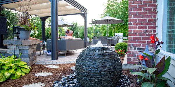 Medium sphere water fountain next to backyard patio
