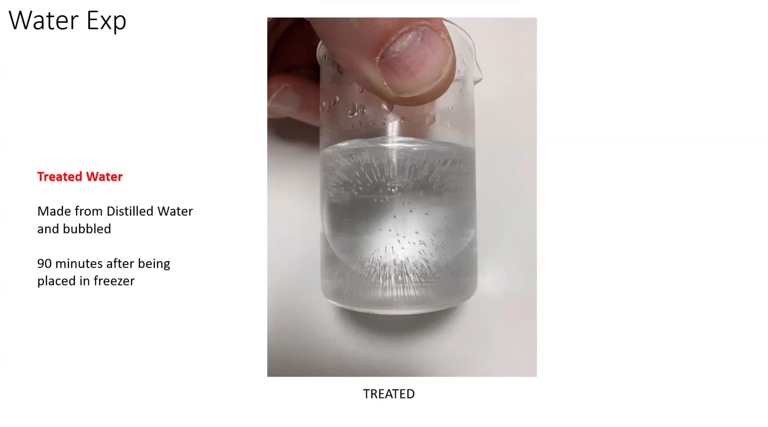 Close-up of treated water in a beaker with bubbles after freezing.