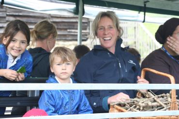A woman and two children on a boat ride.