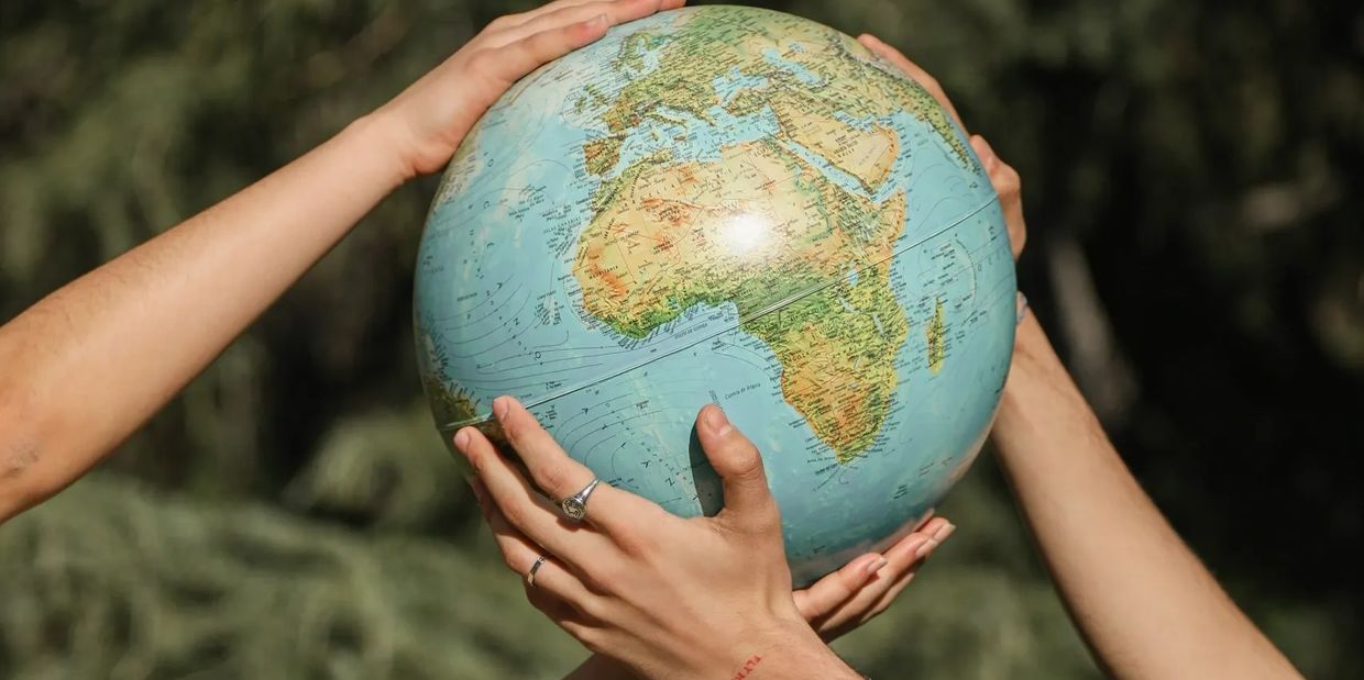 Two hands holding planet Earth Globe