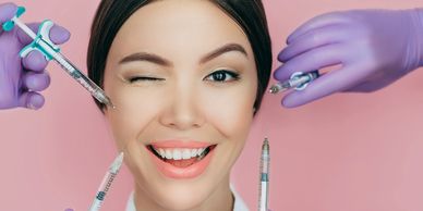 Some hands of a person taking syringe on the face of a girl