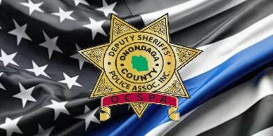 Onondaga County Deputy Sheriffs Police Association badge on a black and white American flag with a blue stripe.