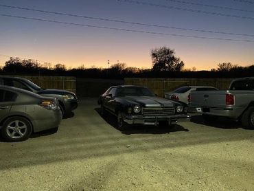 the closed parking lot with various cars stored