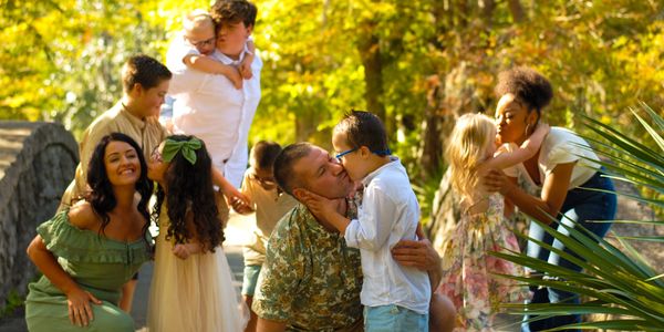 Nathan, Savannah, and family giving kisses.