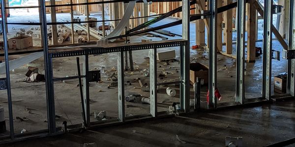 Commercial remodeling showing metal studs and metal boxes with mudrings and other electrical items.