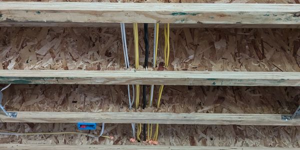 Residential electrical wiring passing through TGI joists in a new construction home. 14/2 12/2 6/3