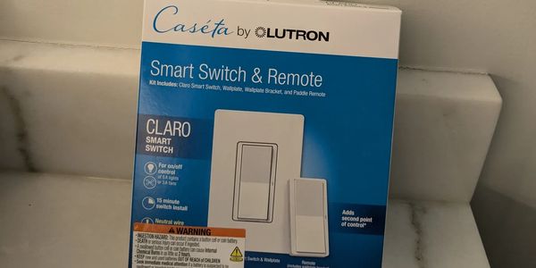 Caseta dimmer switch with wireless remote being changed out in a residential bathroom.
