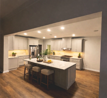Modern kitchen with gray cabinets and a central island with stools.