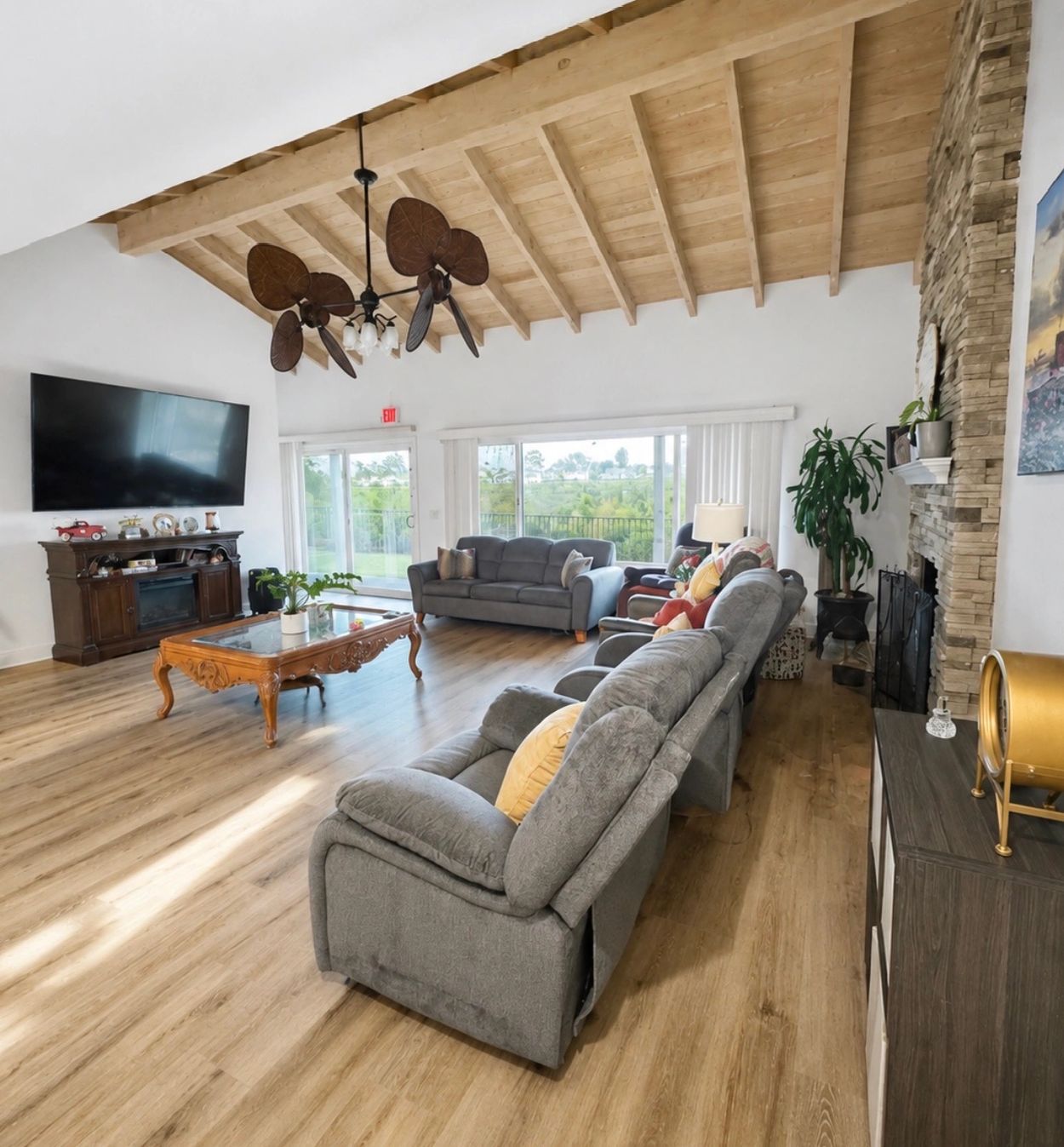 Spacious living room with wooden ceiling and gray upholstered furniture. 