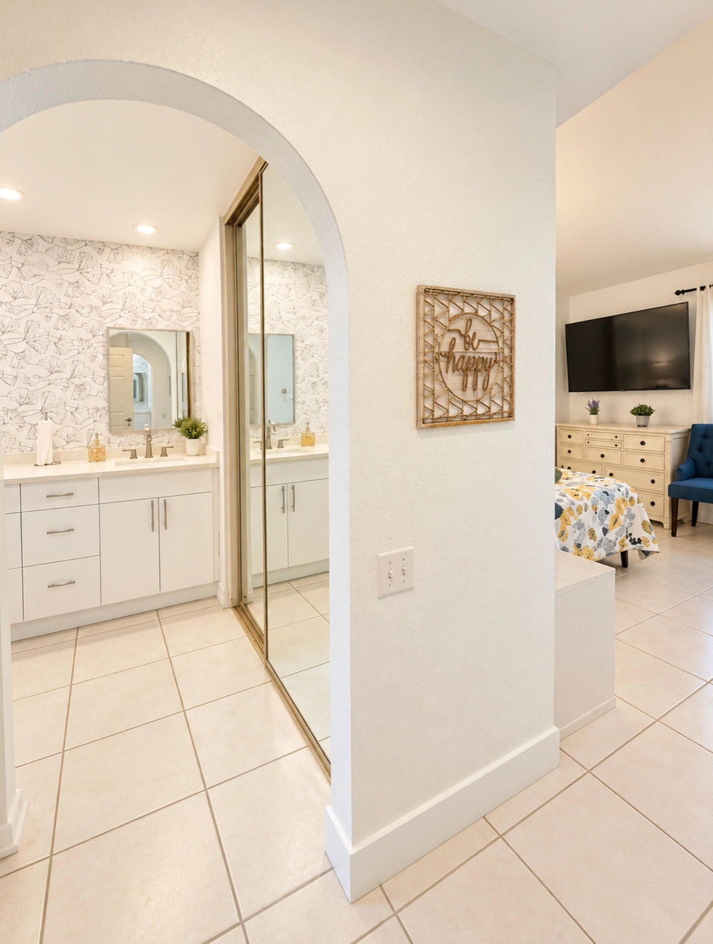 Bright bedroom and bathroom area with modern decor.