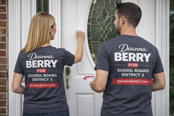 Two people wearing campaign shirts for Deanna Berry, knocking on a door.