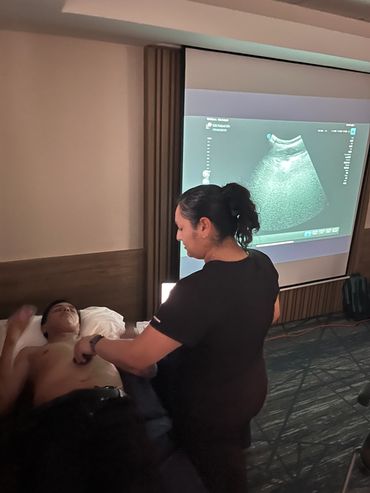 A medical professional performing an ultrasound on a patient's chest.