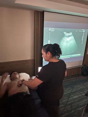 A medical professional performing an ultrasound on a patient's chest.