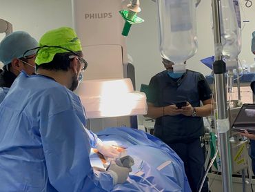 Surgeons performing an operation in a well-equipped operating room.