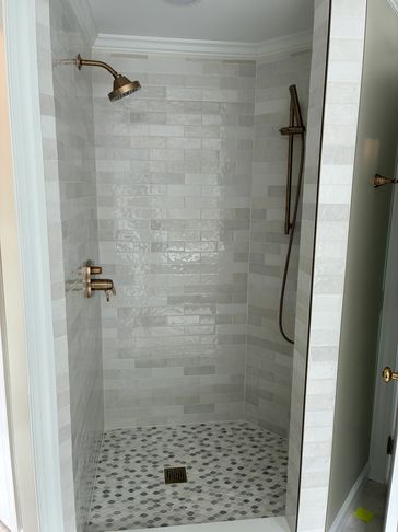 Remodeled tile shower, fixtures and new glass door