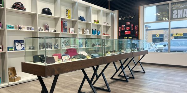 Modern display cases with accessories in a bright retail store.