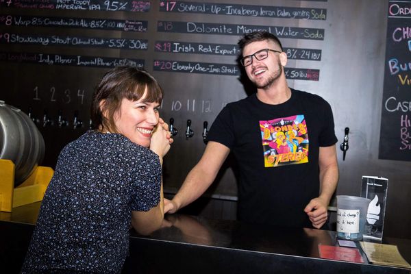 Pub worker interacting with customer photographed by Reichert Photography