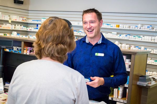Pharmacist talking with client  photographed by Reichert Photography