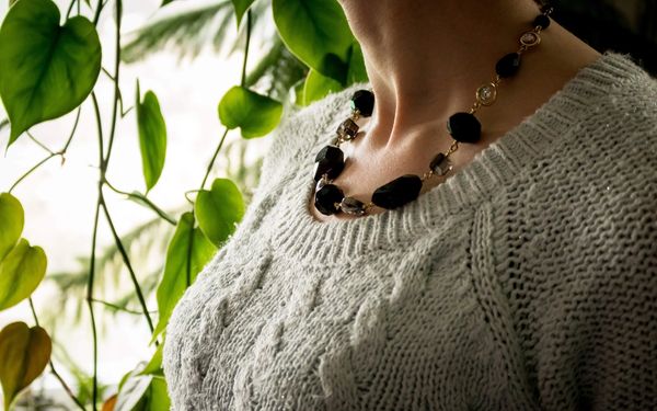 Woman wearing necklace photographed by Reichert Photography