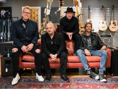 Freddy Jones Band posing on a couch.