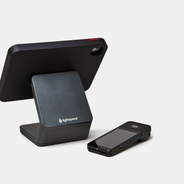 Black smartphone stand and device on a white background.