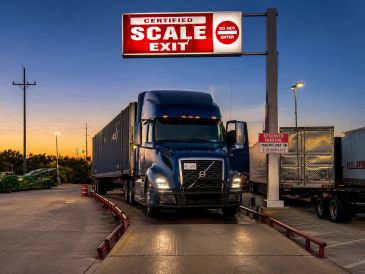 Truck at a certified scale exit during sunset.